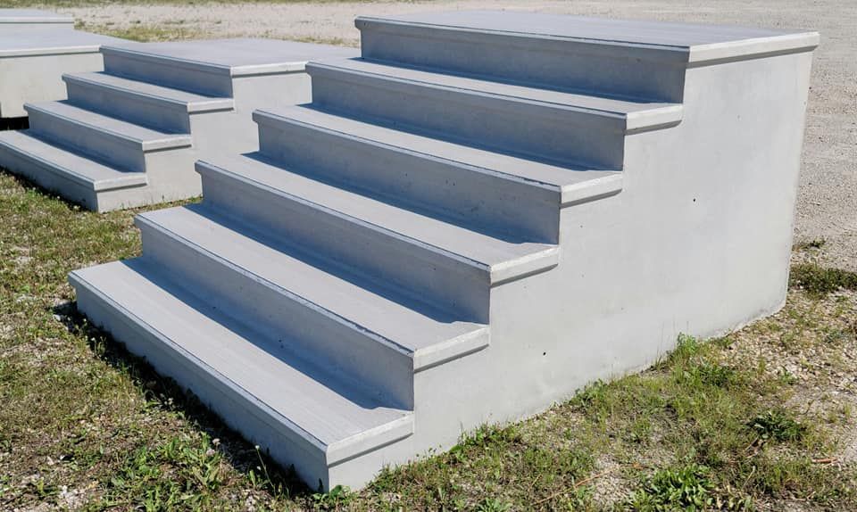 Outdoor concrete steps painted white with blue-gray treads on a grassy area