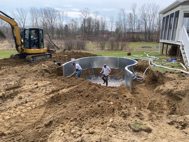 A man is digging a hole in the ground to build a pool.