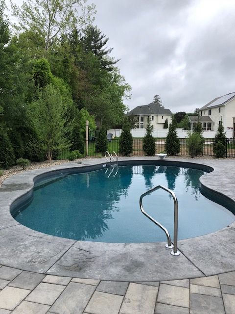 a large swimming pool with stairs leading to it