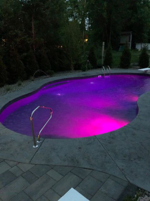 a swimming pool with purple lights on it