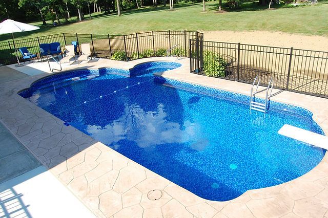 A large swimming pool with a fence around it