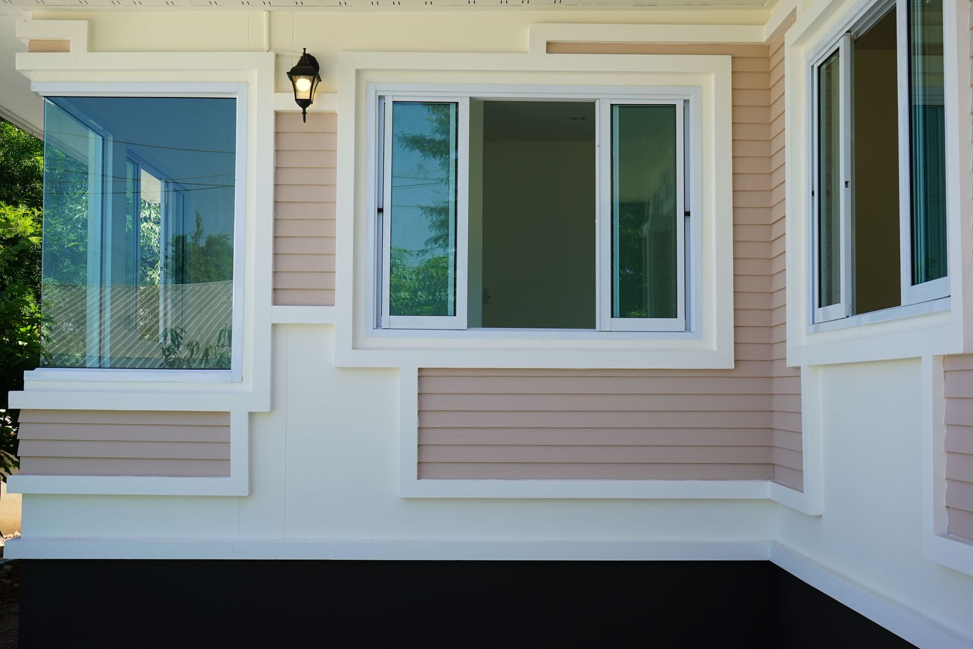 Front porch exterior with beige siding, white trim, and large windows