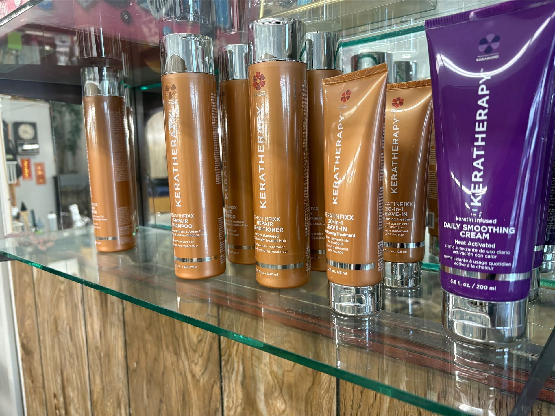 Hair care products on a shelf: brown bottles and tubes of