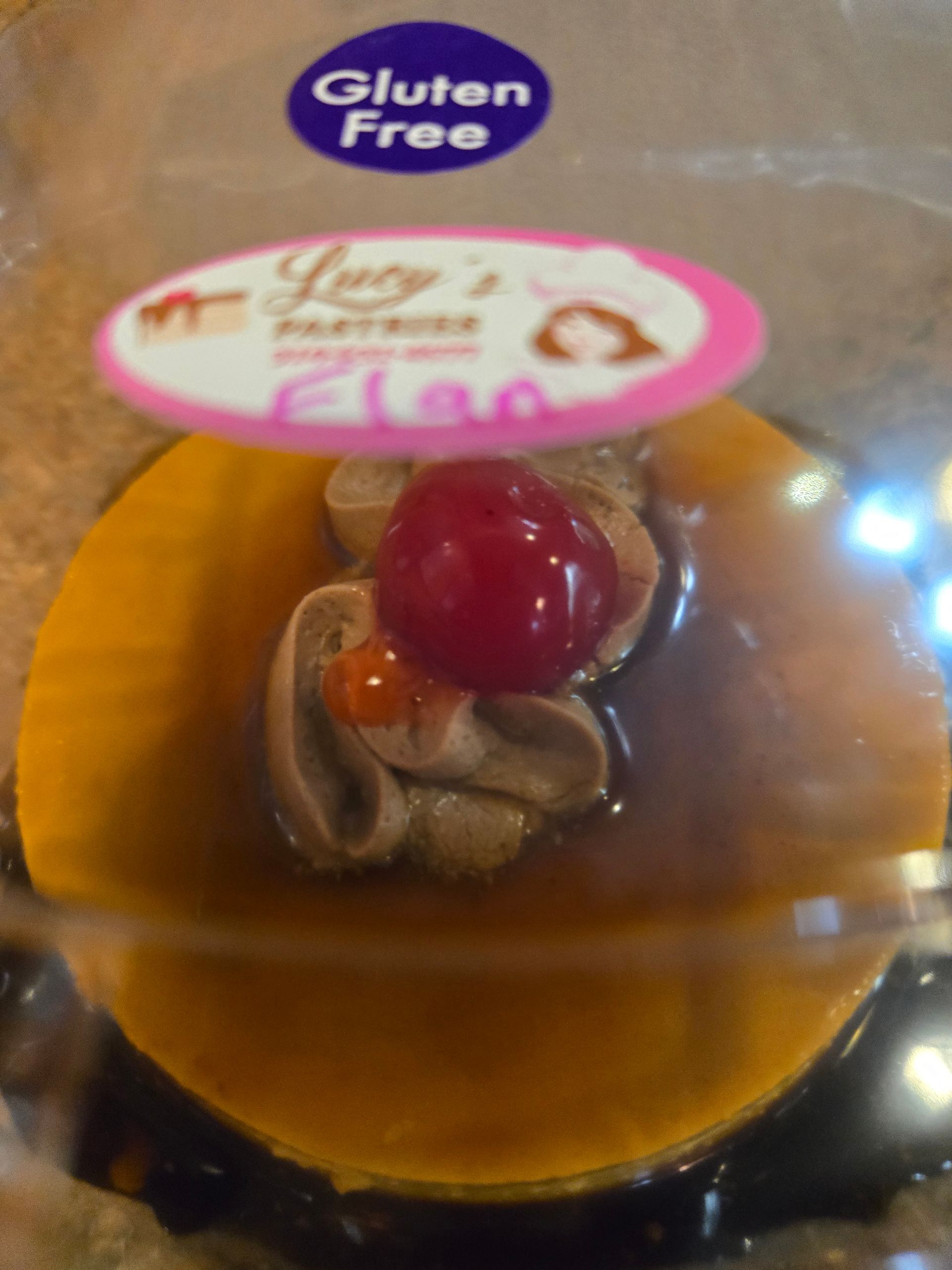 A gluten free cake with a cherry on top