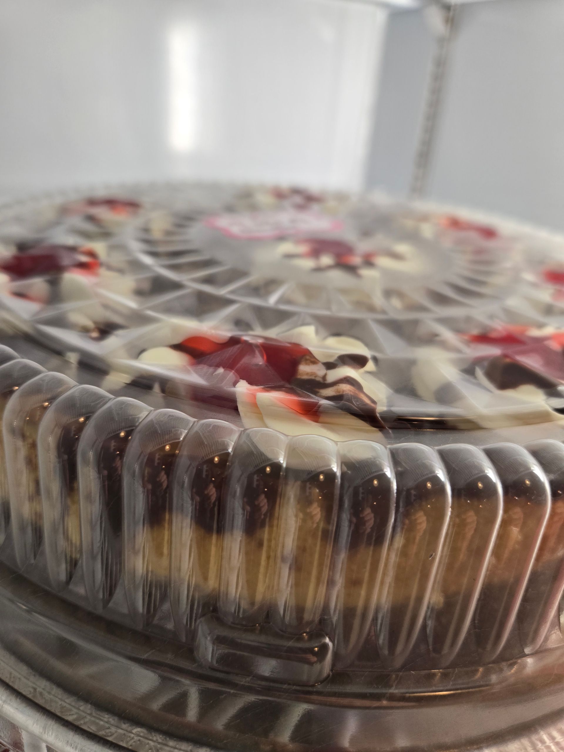 A close up of a cheesecake in a plastic container