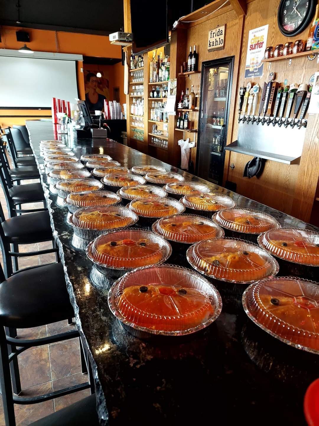 A long bar with a lot of plates of food on it.