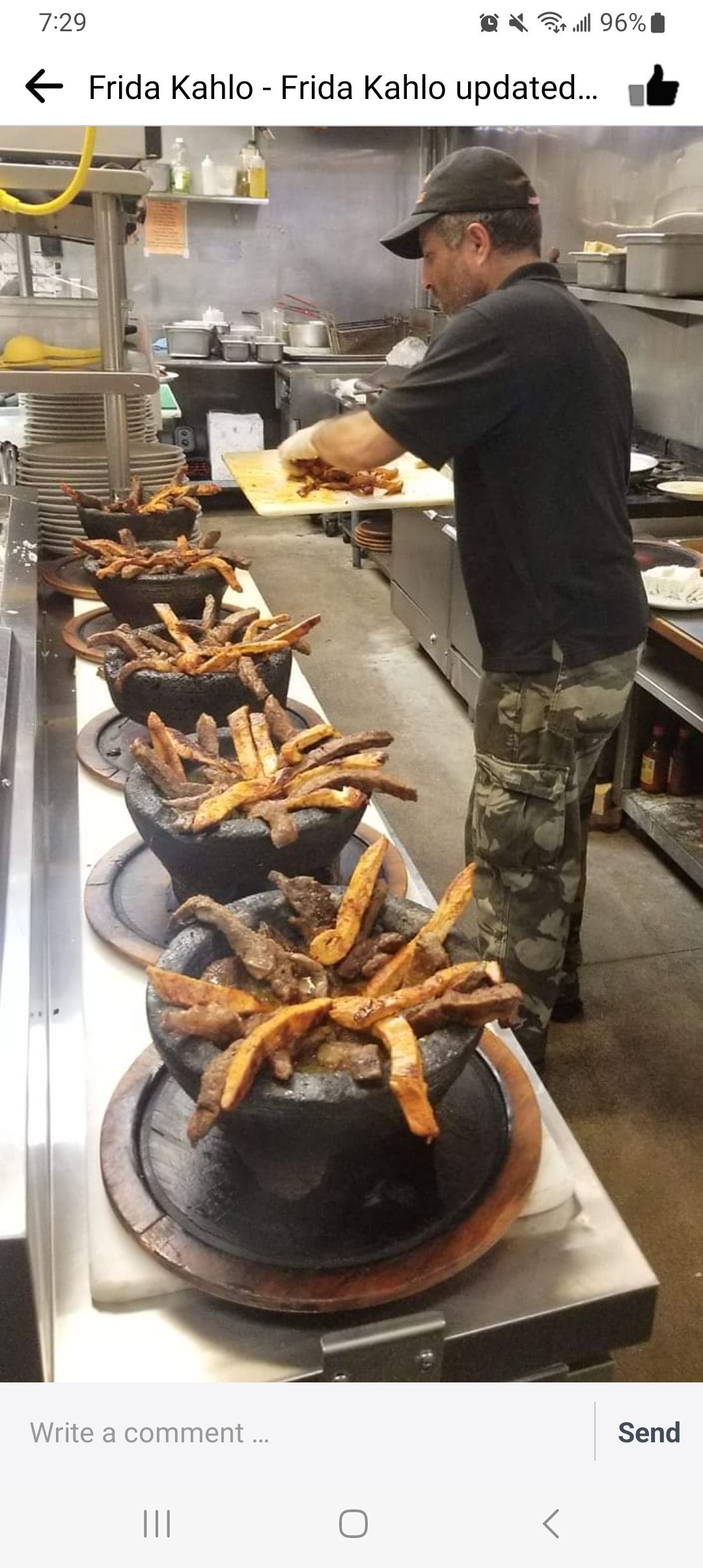 A man is standing in a kitchen preparing food.