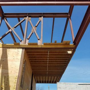 The roof of a building under construction with a blue sky in the background.