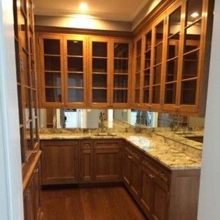 A kitchen with wooden cabinets and granite counter tops.