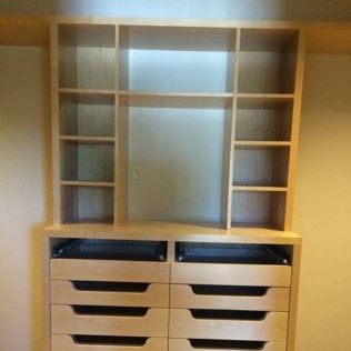 A closet with lots of shelves and drawers in it