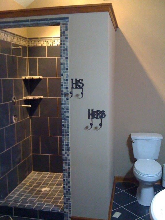 Bathroom with a tiled shower, toilet, and 