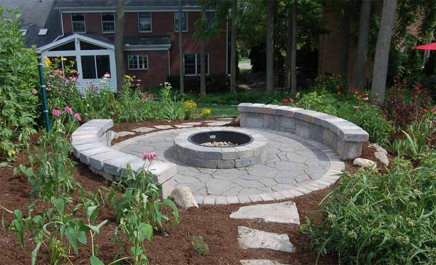 There is a fire pit in the middle of the garden.