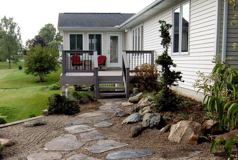 A house with a deck and stairs leading to it