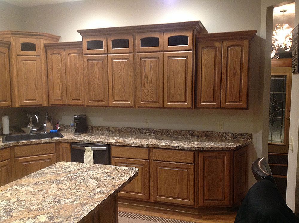 Kitchen with oak cabinets, granite countertops, and a matching island.