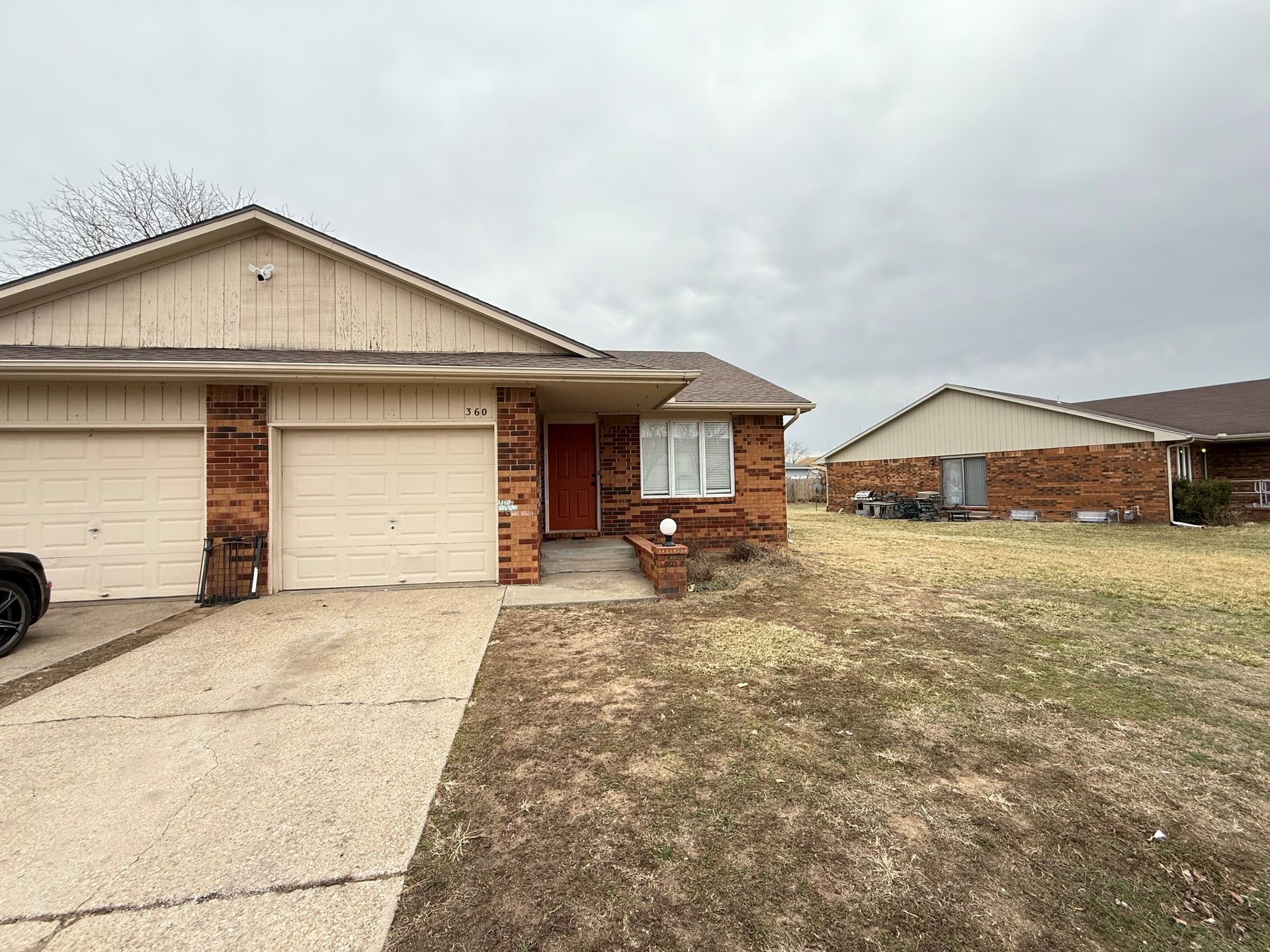 A house with a car parked in front of it.