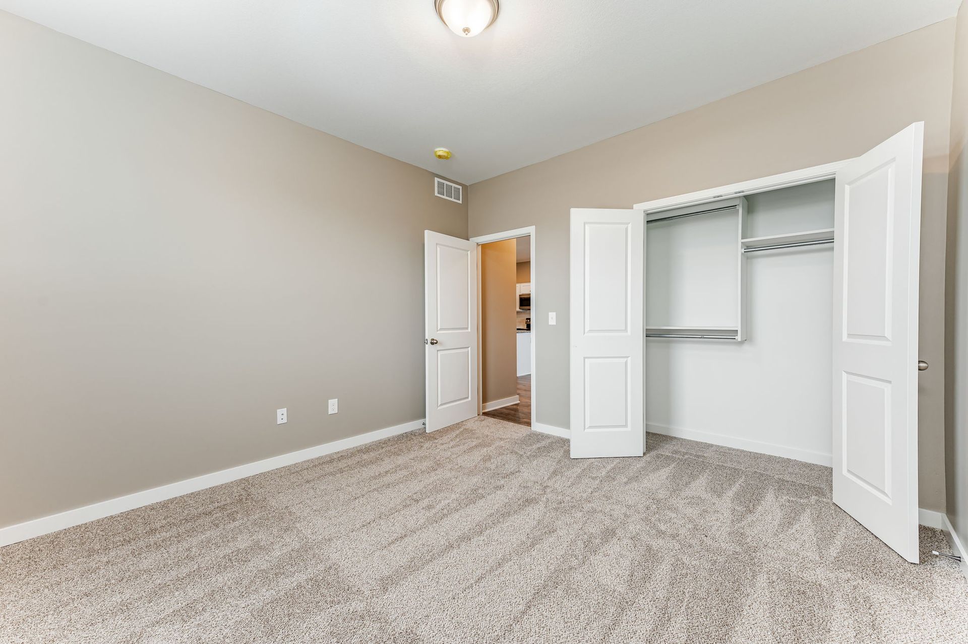 An empty bedroom with a closet and a walk in closet.