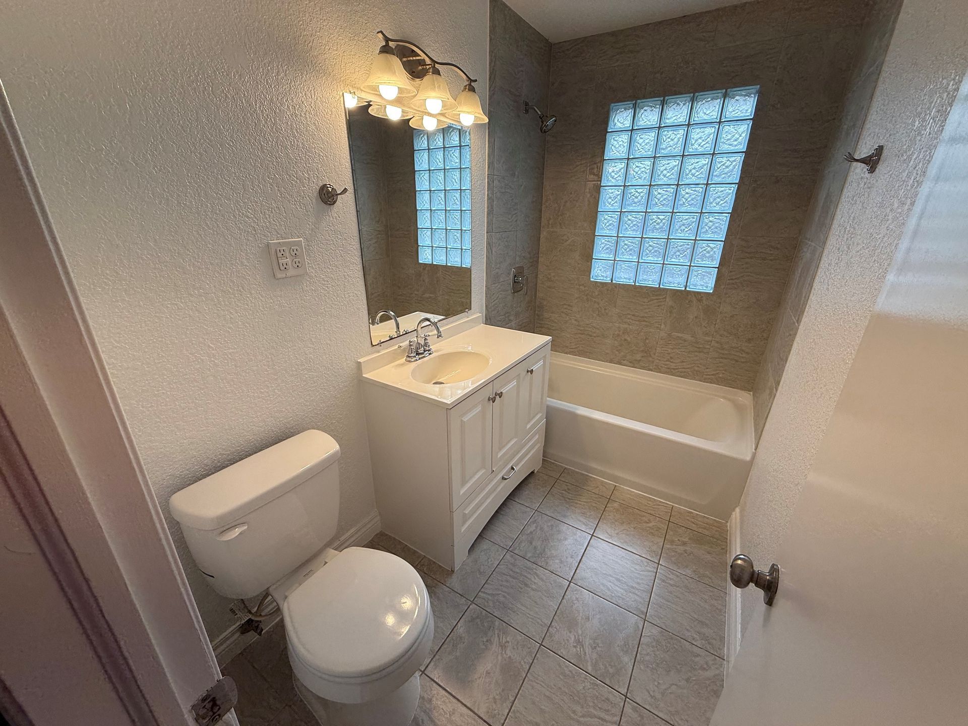 A bathroom with a toilet , sink and bathtub