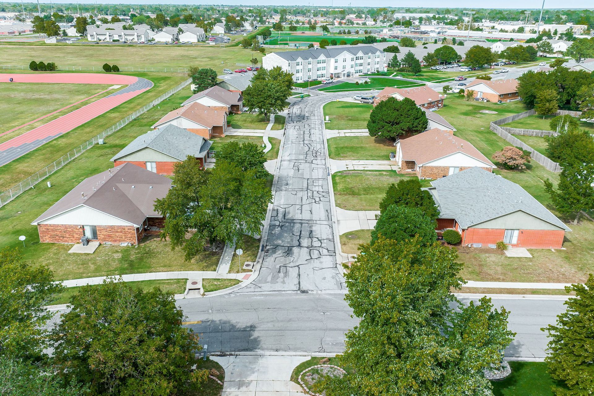 An aerial view of a residential area with houses and trees