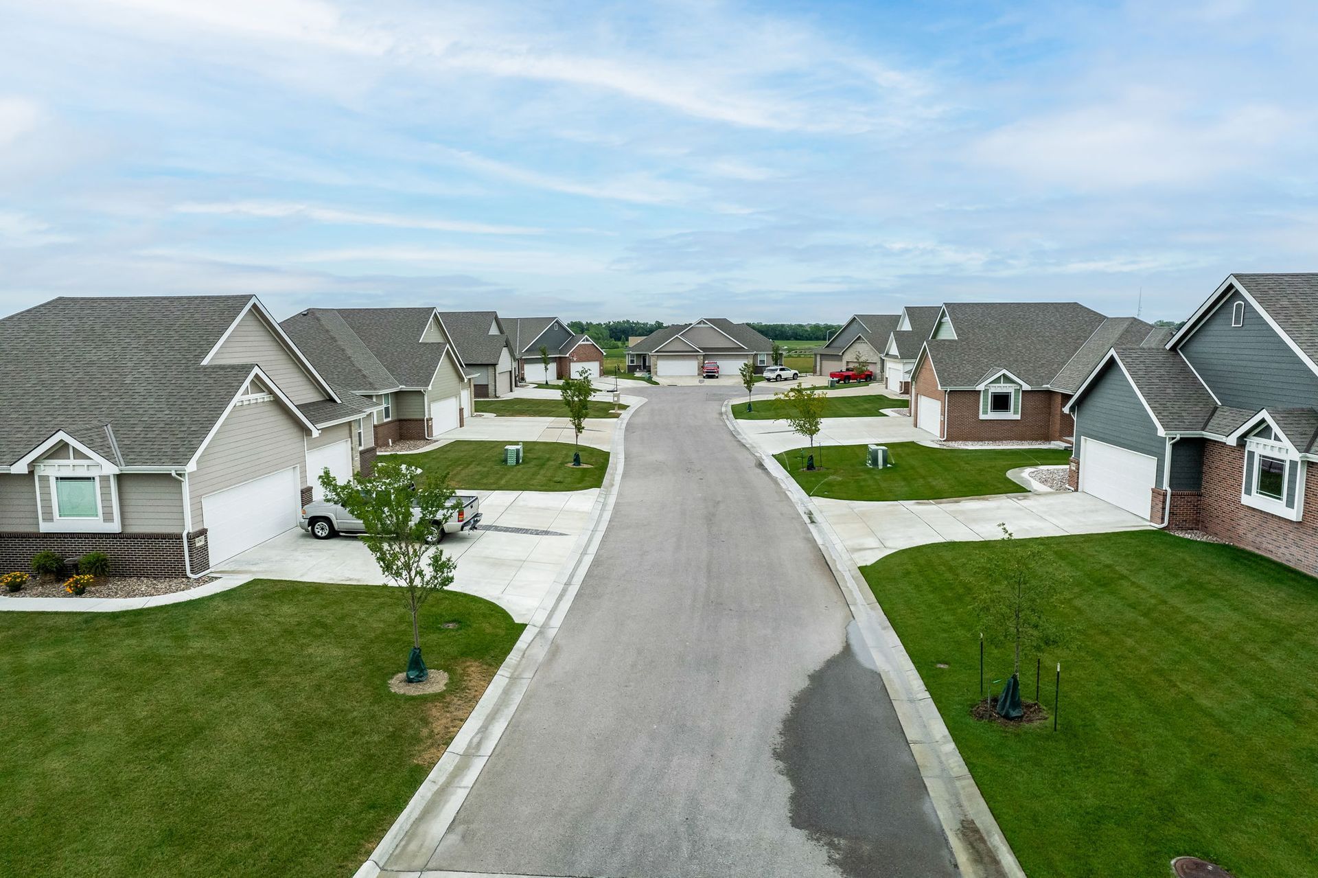 An aerial view of a residential neighborhood with houses and a road.