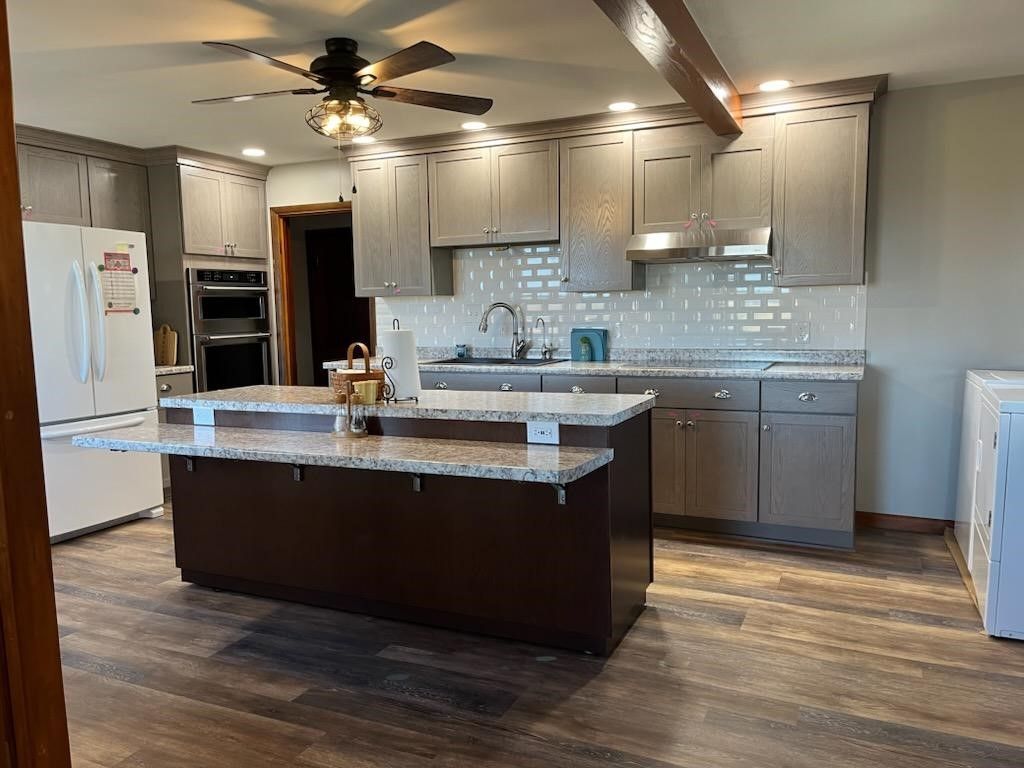 kitchen with a large island and a ceiling fan
