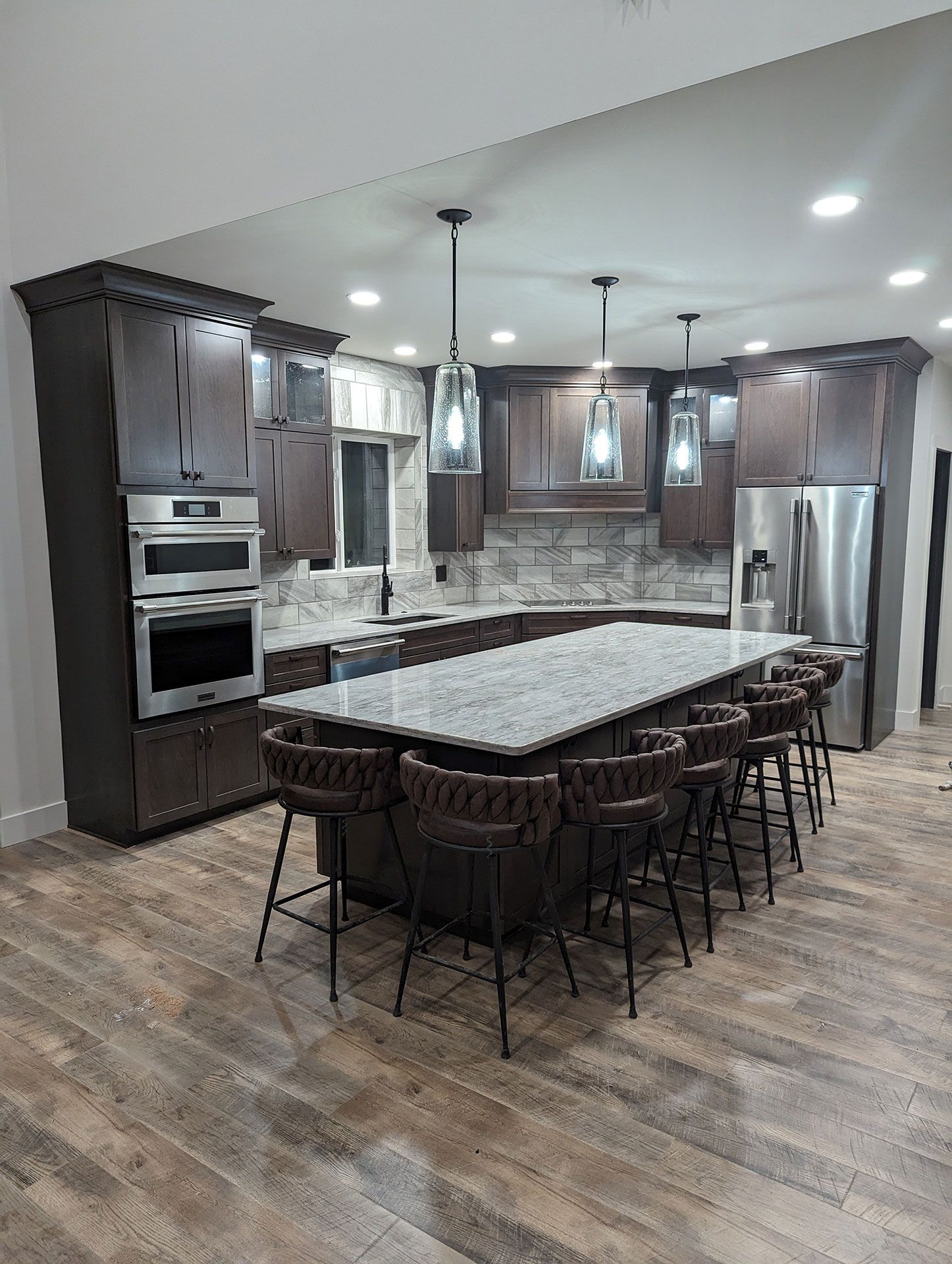 A kitchen with stainless steel appliances and a large island