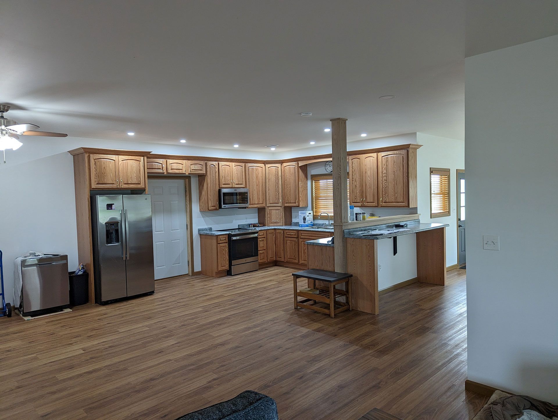 A kitchen with wooden cabinets and stainless steel appliances in a mobile home