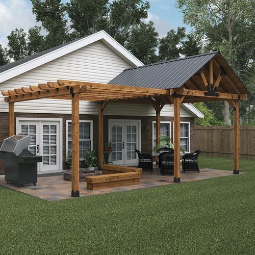 a house with a pergola and a grill in the backyard