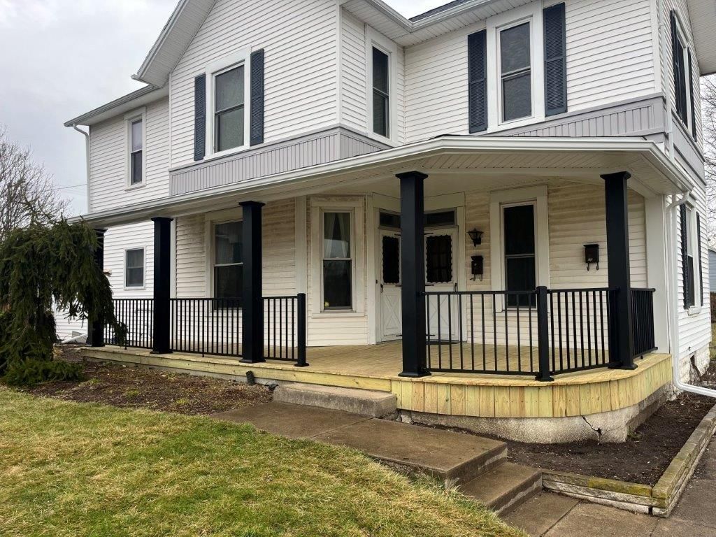 A large white house with a large porch