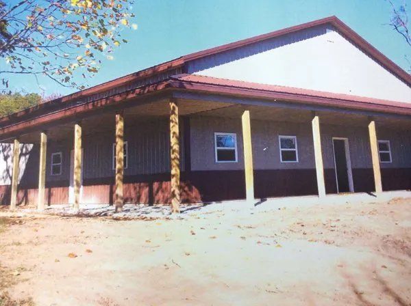 A picture of a house with a porch and pillars