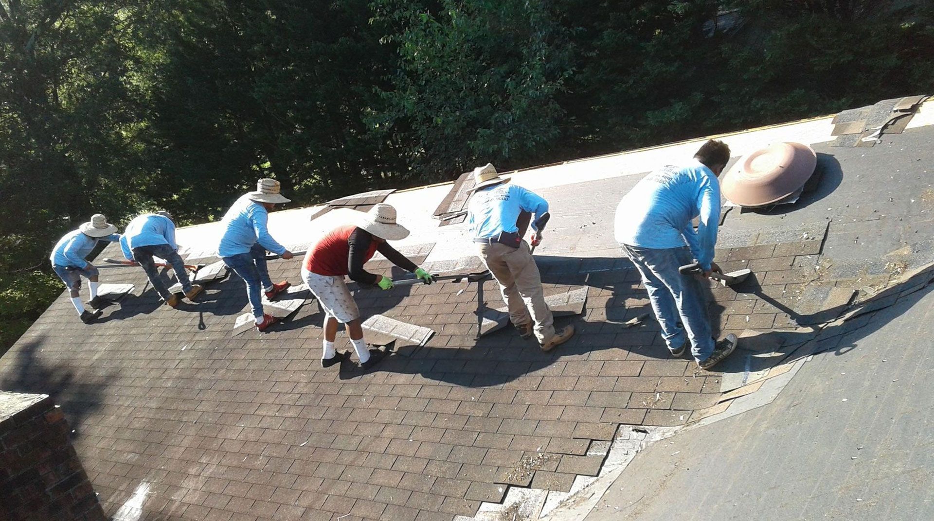 a group of people are working on a roof