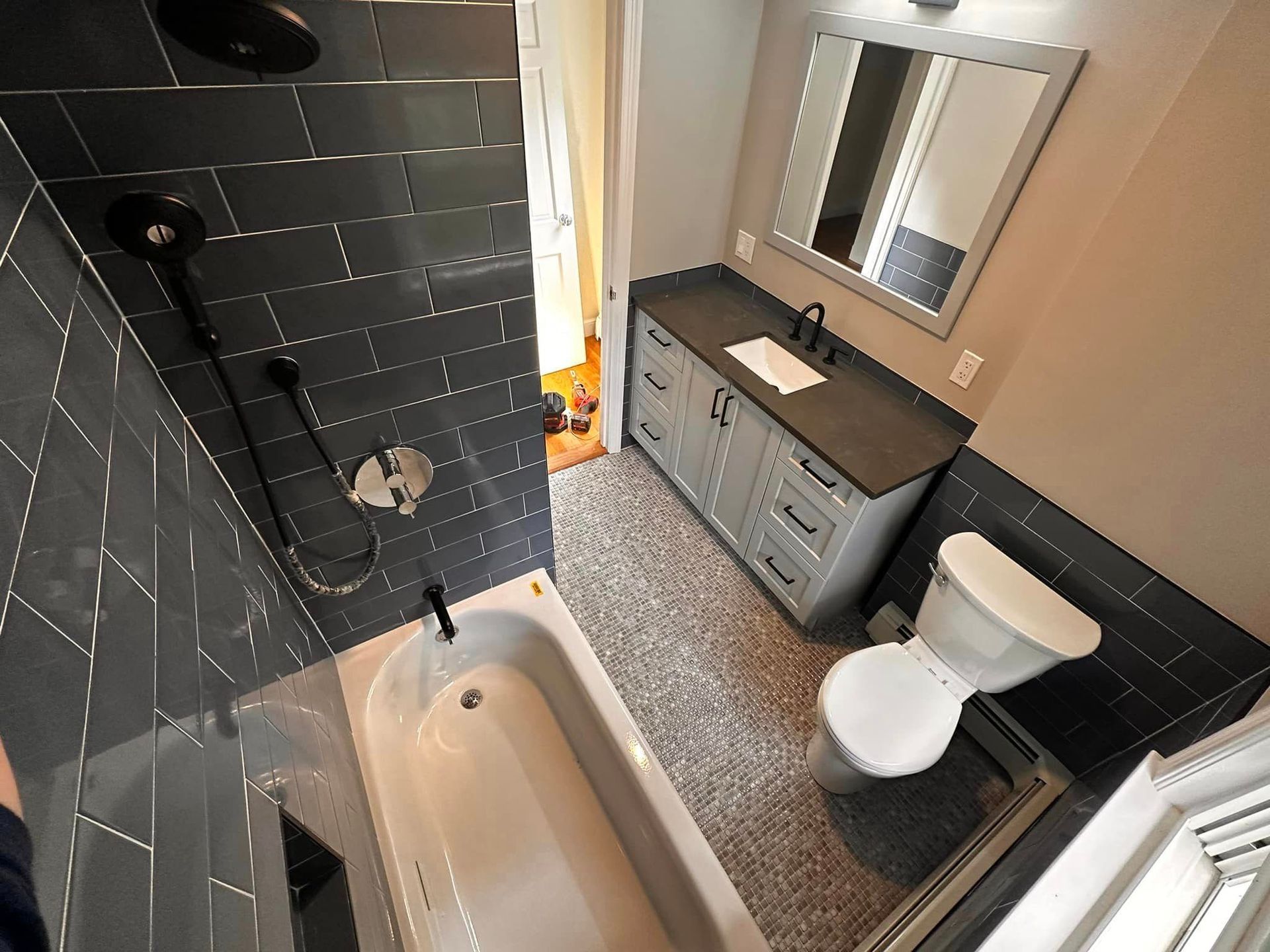 A bathroom with a tub a toilet and a shower