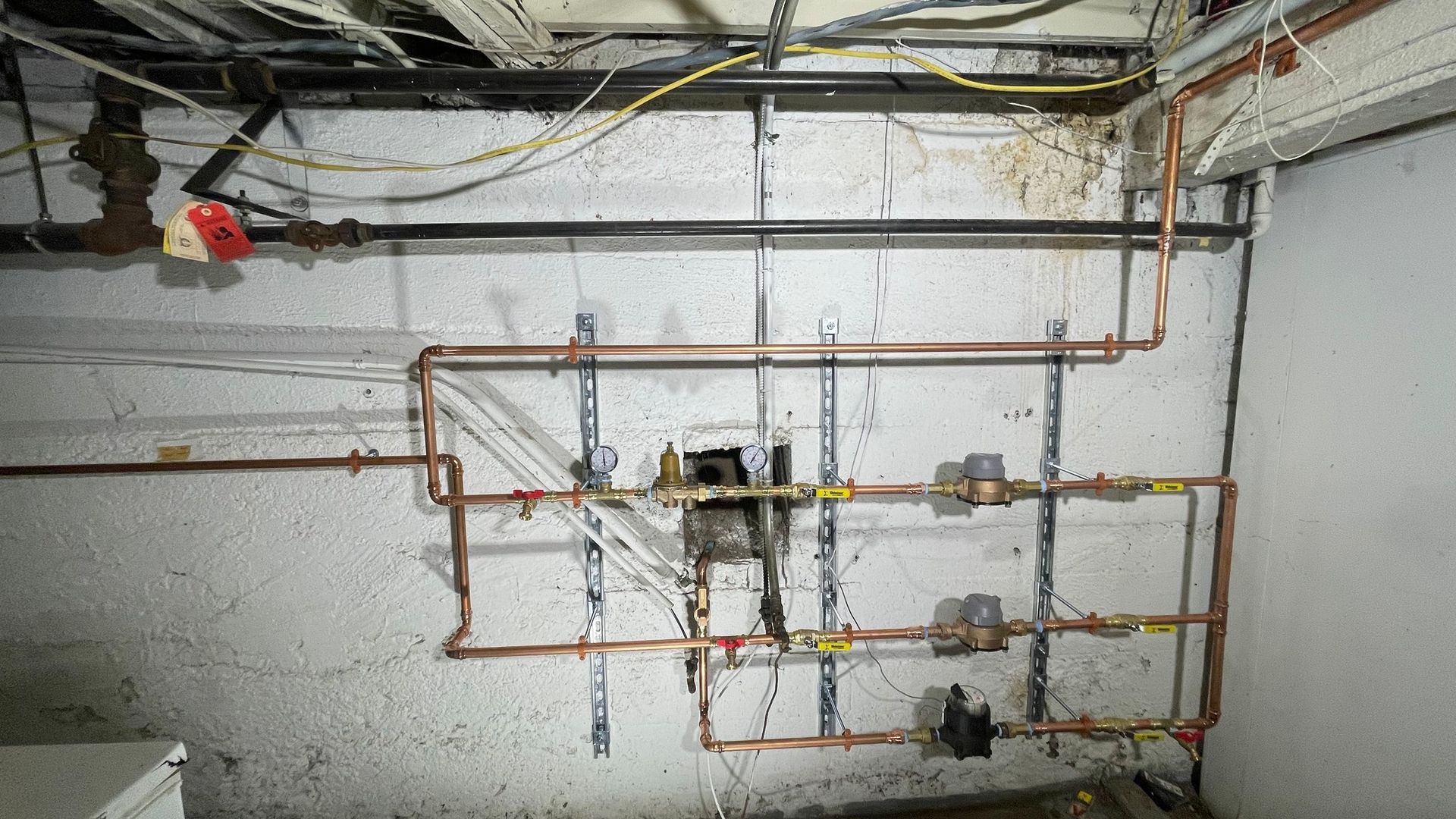 A room with a lot of pipes on the wall