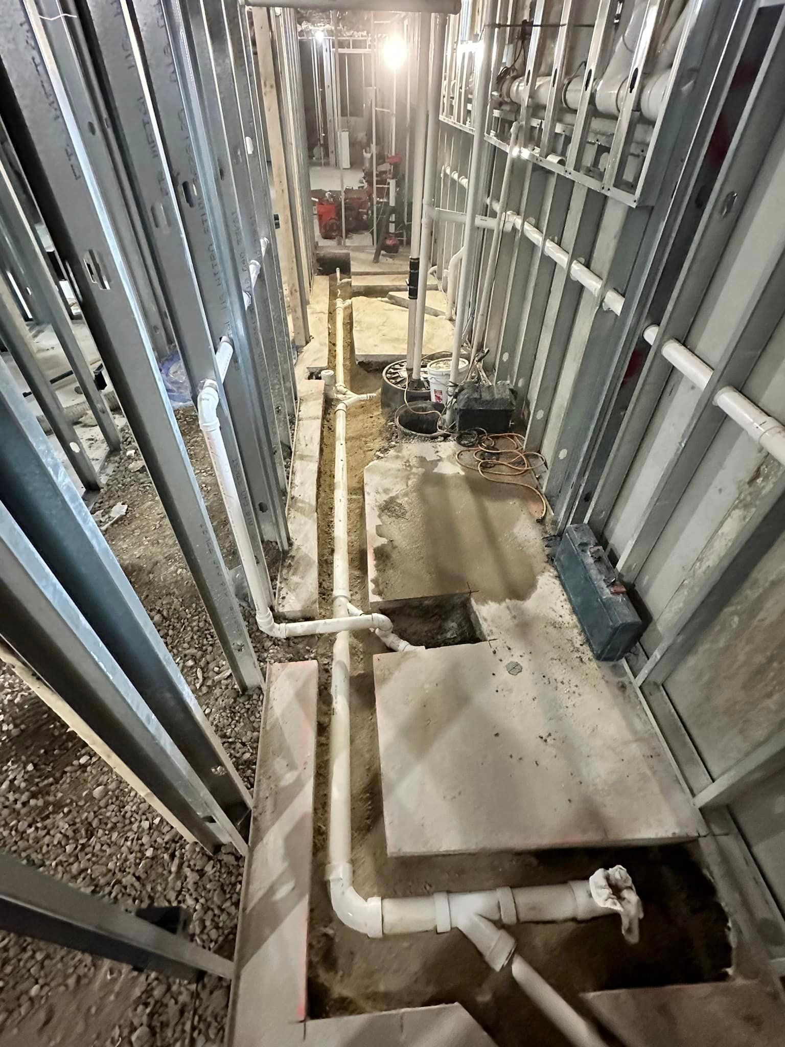 A building under construction with a lot of pipes going through it.