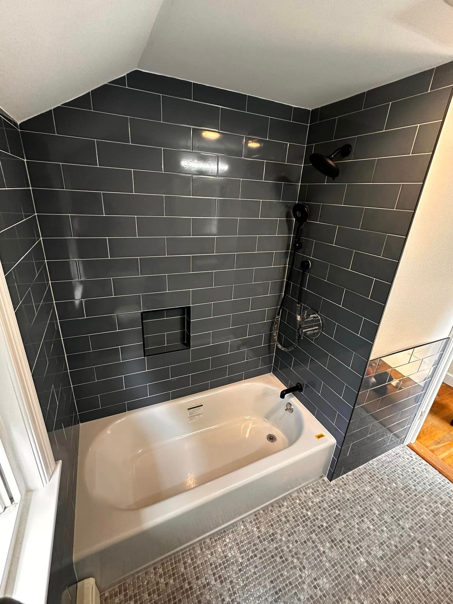 A bathroom with a bathtub and a shower.