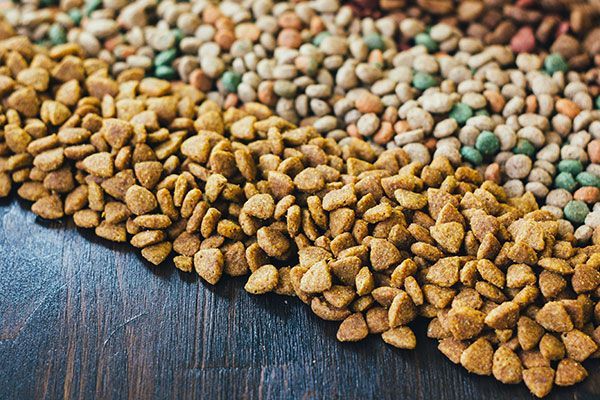 A pile of cat food on a wooden table.