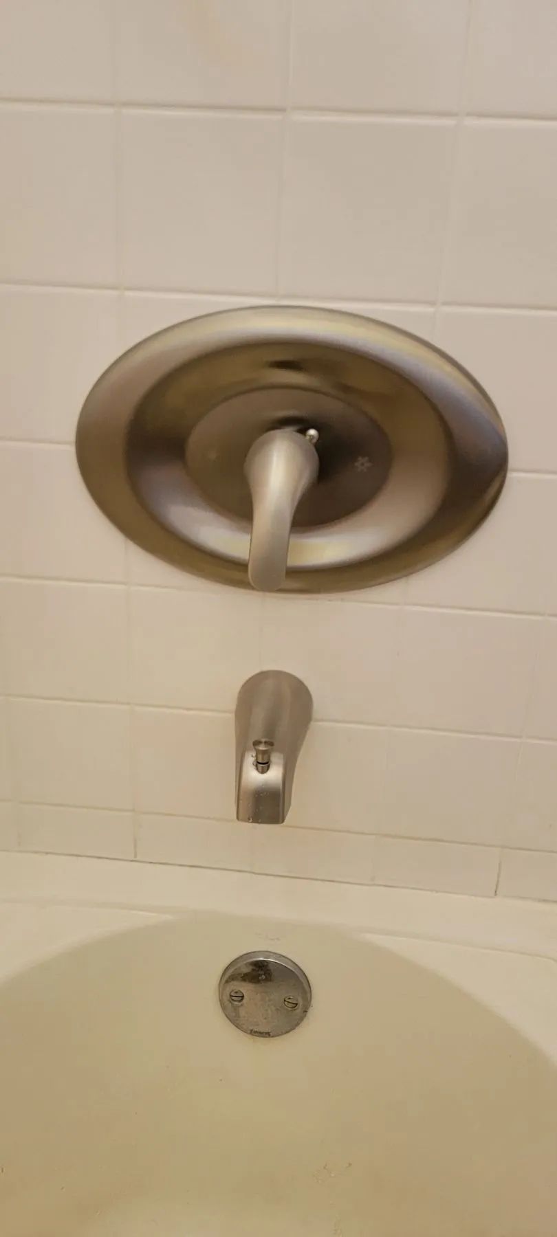 Bathtub and shower faucet with tile wall in a bathroom