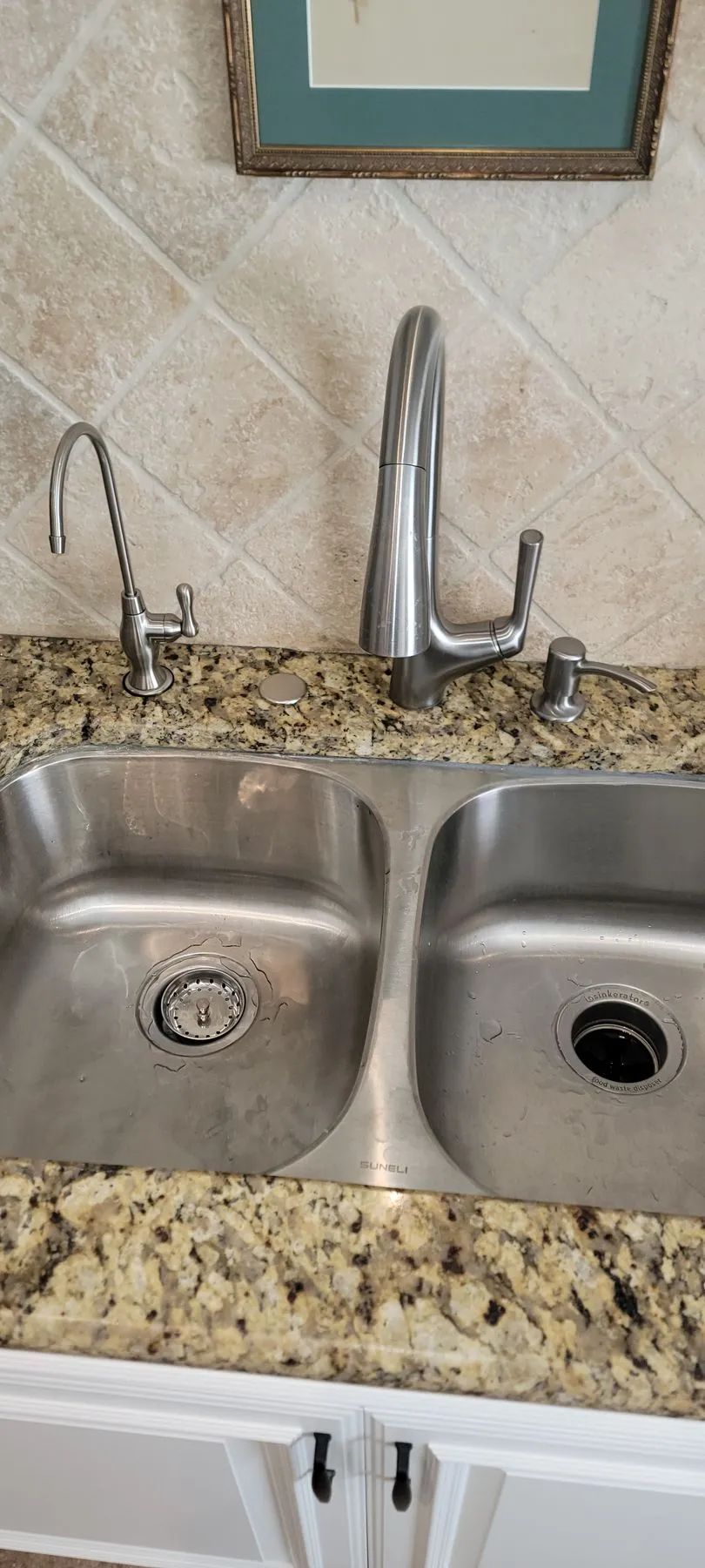 Kitchen double sink with granite countertop and chrome faucet