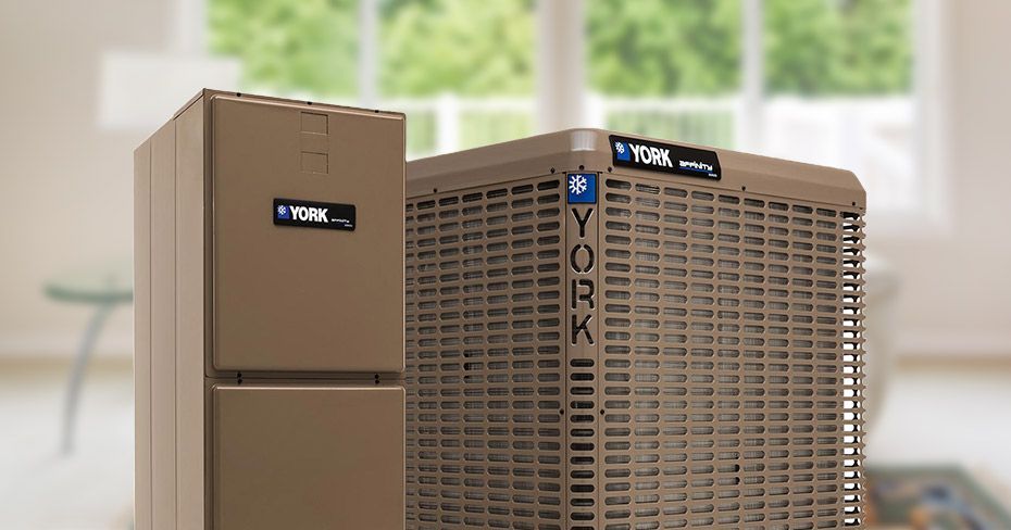 York HVAC unit in a bright room, with a beige cabinet beside a tan outdoor condenser unit.