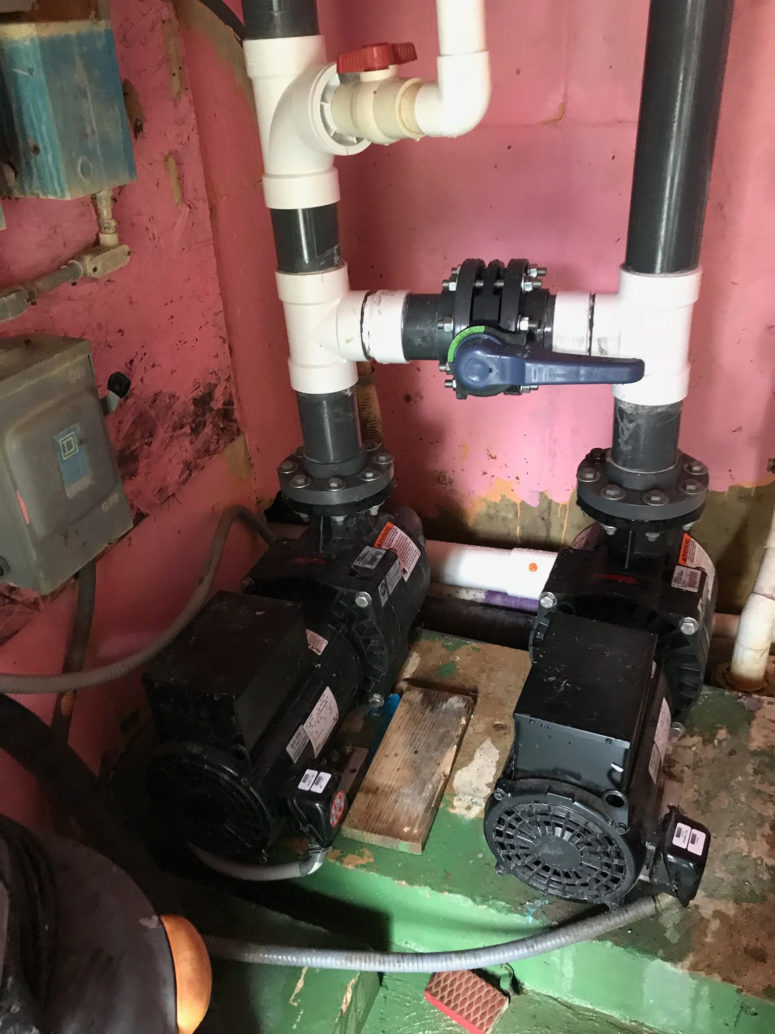 A room with a lot of pipes and pumps in it.