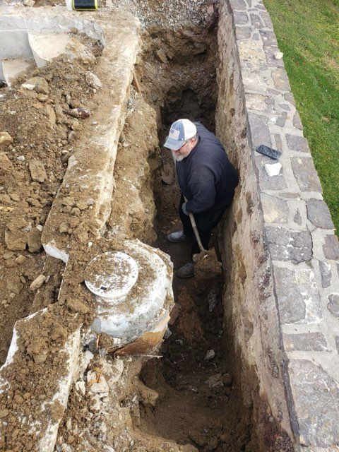 A man is digging in the dirt with a shovel