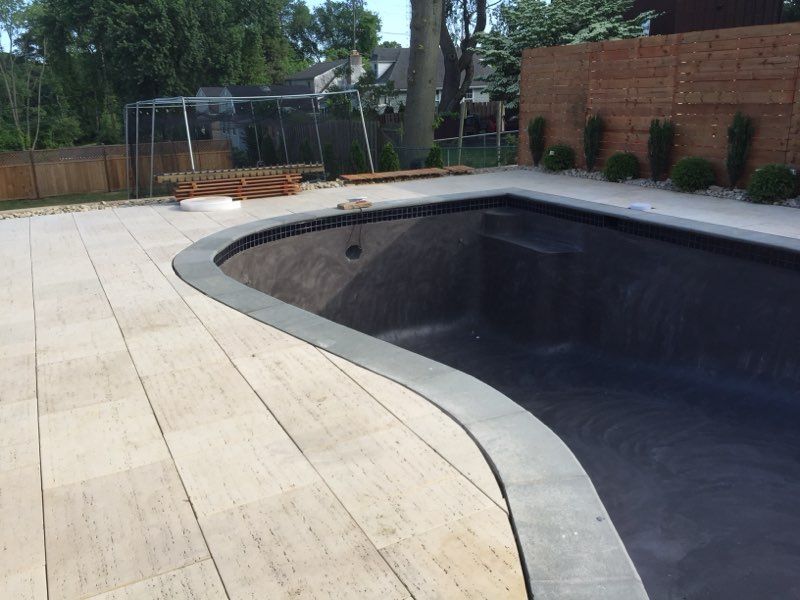 A swimming pool is being built in a backyard