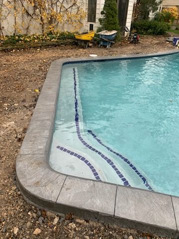 A swimming pool is being built in the backyard of a house.