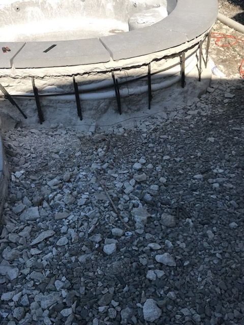 A concrete structure is being built on top of a pile of rocks.
