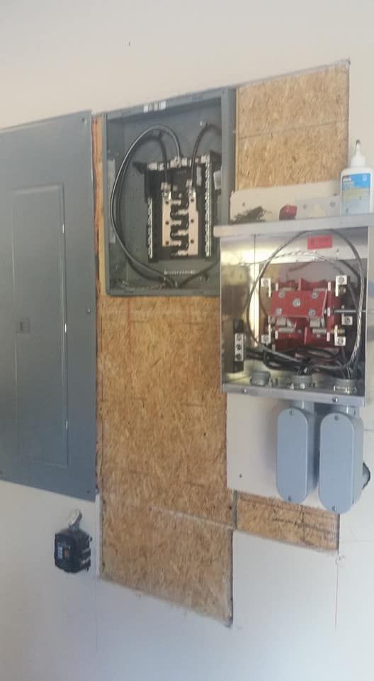 A electrical box is sitting on a wall next to a shelf.