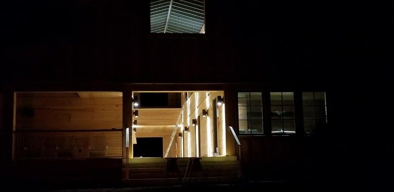 The front of a house is lit up at night.