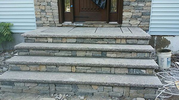 A set of stone steps leading up to the front door of a house