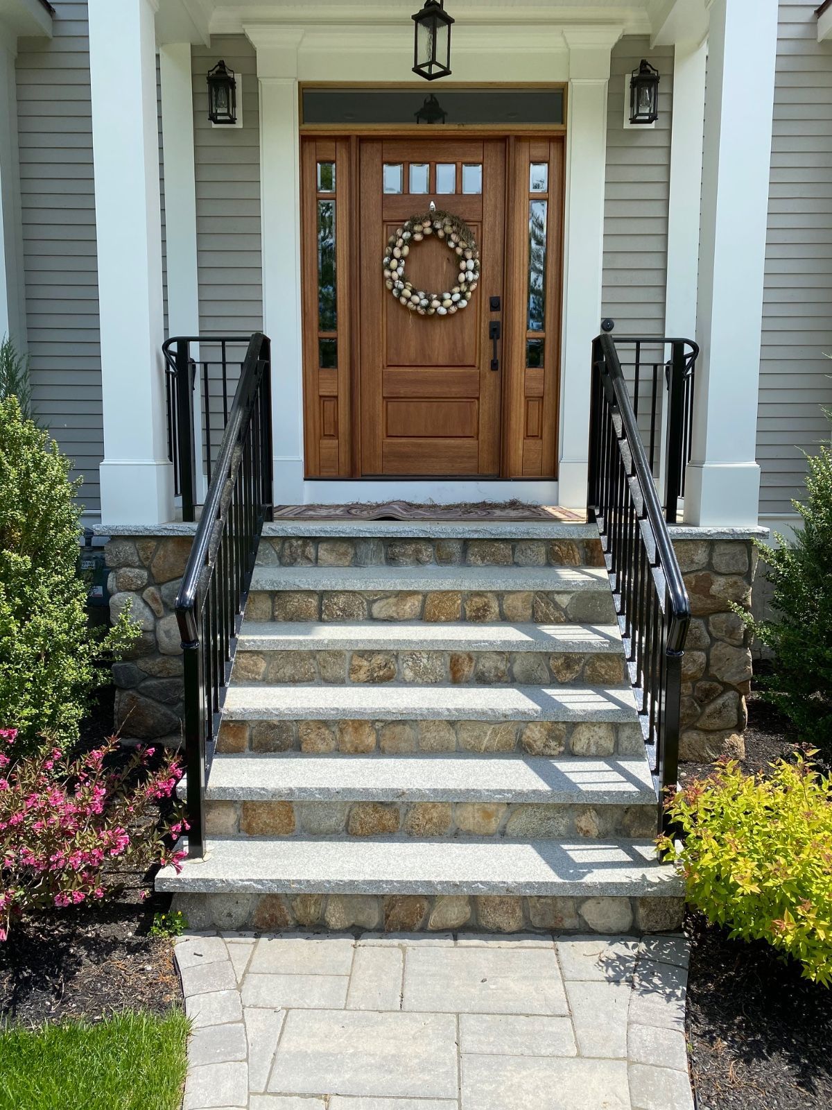 The front door of a house has a wreath on it