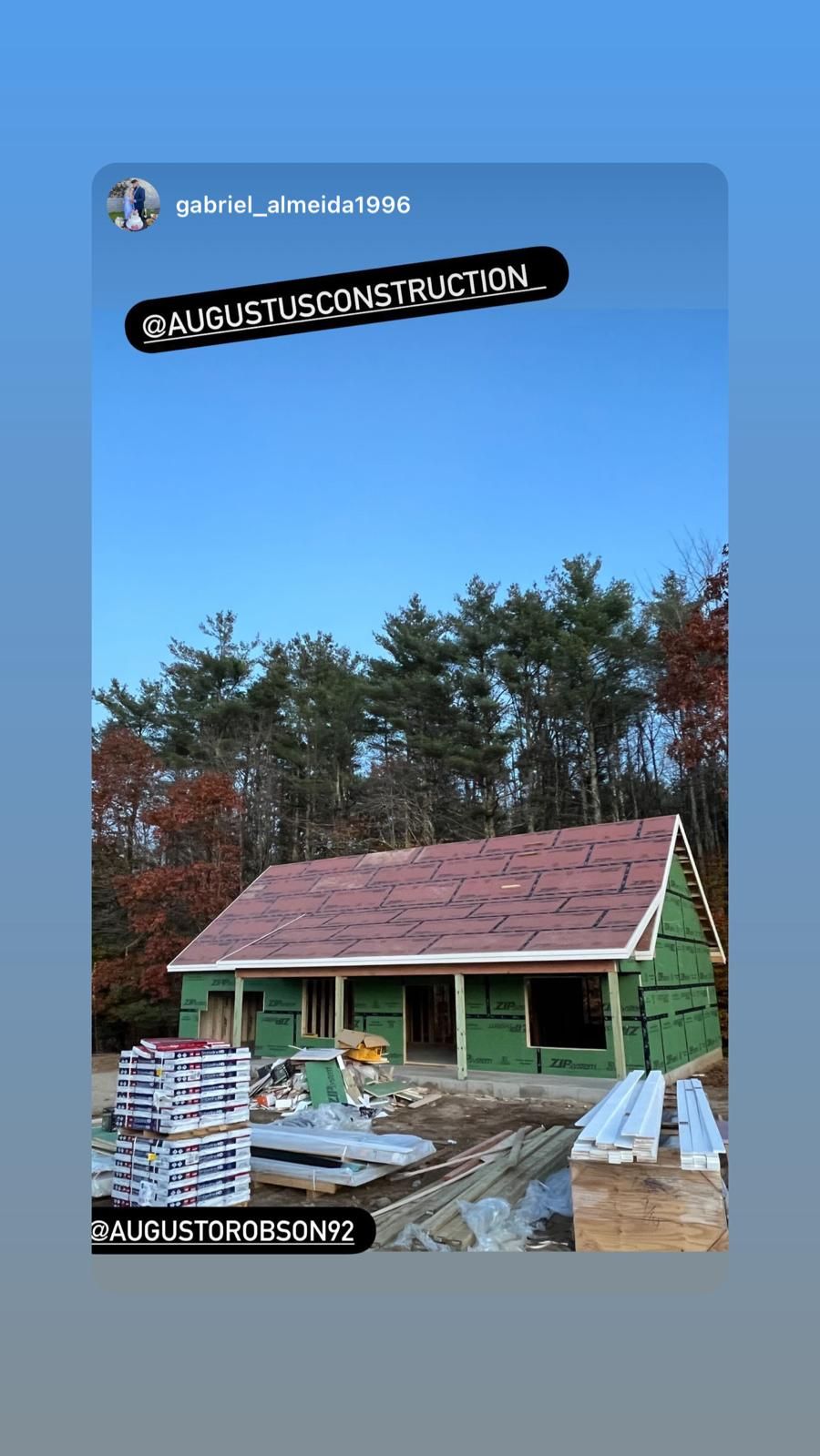 A picture of a house under construction with a red roof.