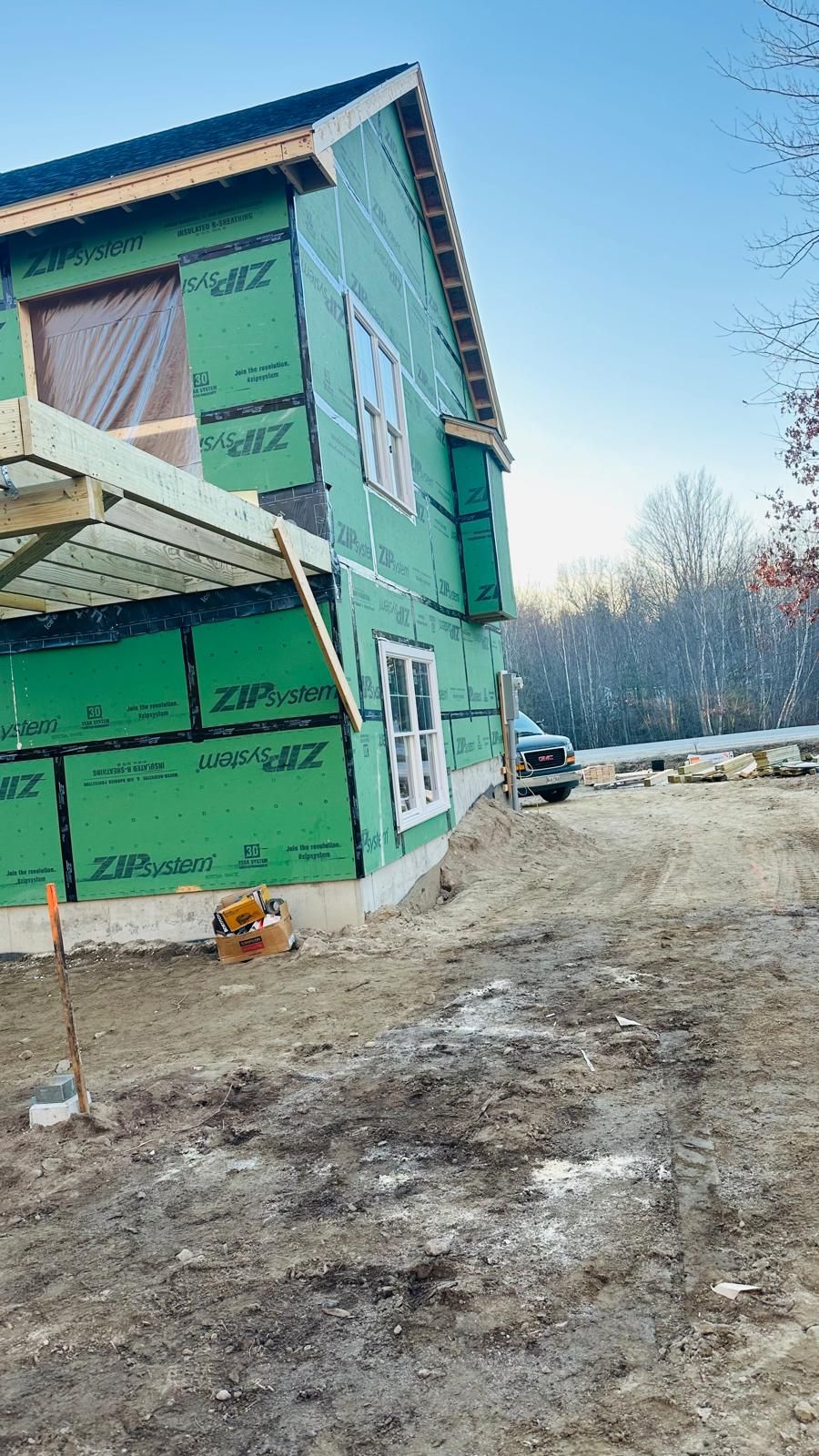 A house is being built in the middle of a dirt field.