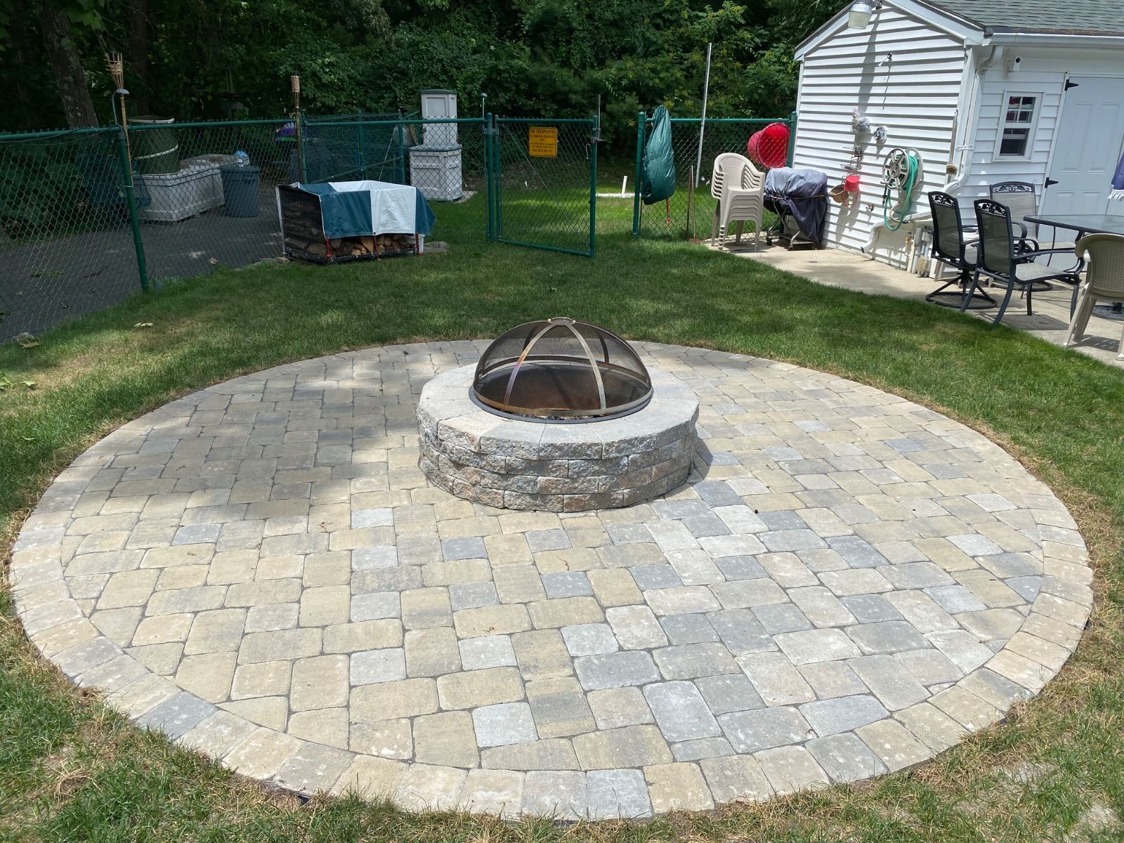 There is a fire pit in the middle of the patio.